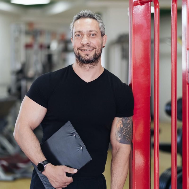 personal-fitness-trainer-with-workout-plan-close-up-on-gym-background-1.jpg